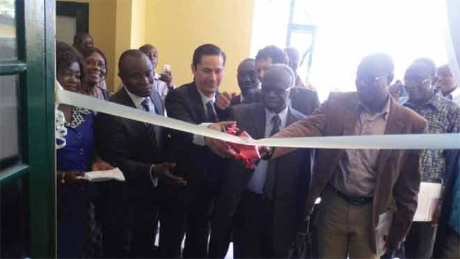 Dr Victor Agyemang (4th left ), the Director-General of the CSIR, being assisted by Mr Daniel Lauchenauer (3rd left) to cut the tape to inaugurate the refurbished laboratory